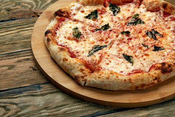 Whole neapolitan pizza served on wooden board