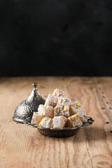 Turkish Delight with pistachio on wooden background