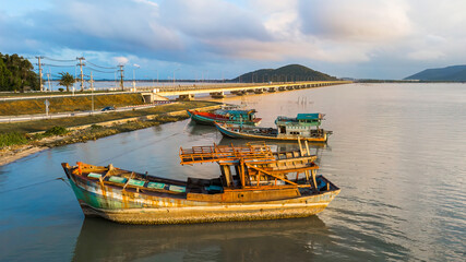 Fototapeta na wymiar A fishing boat moored at the shore on a beautiful sunrise.