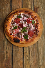 Meat Italian pizza with roast beef, steak slices, melted cheese, with olive slices and cheddar cheese. Close up, macro. Pizza time concept.