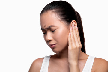 Asian woman having ear pain, white studio background