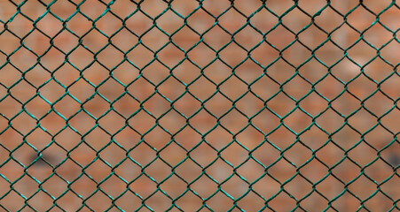 A fence made of a metal mesh close-up. Abstract background.