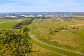 Fototapeta na wymiar Aerial photo of the Pontefract race course located in the town of Pontefract in West Yorkshire in the UK, showing the main building and horse racing course, with the town of Castleford in the back