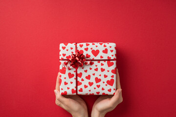 First person top view photo of valentine's day decorations female hands demonstrating gift box in...