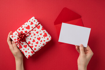 First person top view photo of valentine's day decor hands holding paper sheet over envelope and...