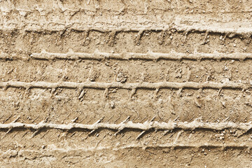 Sand tyre mark background. Tire track shape. Trail lines on dry brown sand pattern. Road construction site backdrop. Heavy machinery imprint. Dried mud vehicle wheel shape.