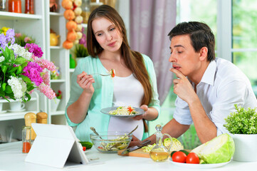 Portrait of happy husband and wife cooking together