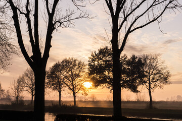 Fototapeta na wymiar Beautiful sunset in winter season at the lake in Netherland.