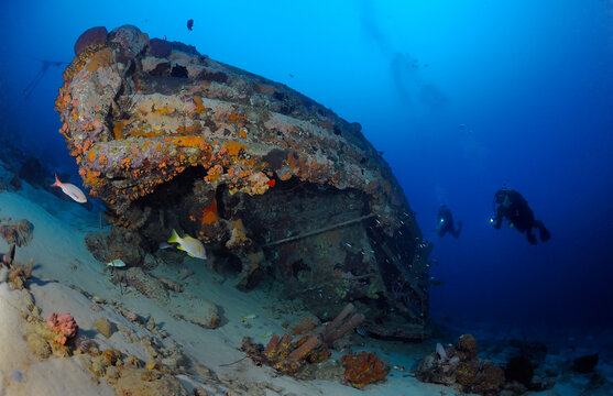 Divers explore tug boat wreck, Bonaire Island, Netherlands Antilles, Caribbean