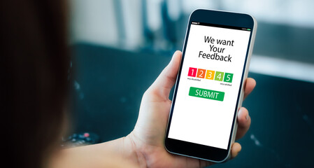 customer feedback experience,review concept.Hands holding mobile phone
