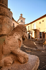 The lion head of an ancient statue in a street of Pignola, a medieval village in the Basilicata region of Italy.