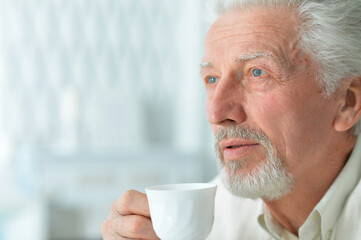 Portrait of smiling senior man drinking coffee