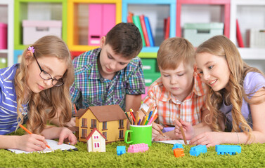 Fototapeta premium Close up portrait of group of children drawing with pencils