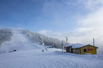 Fototapeta na wymiar Beautiful snowy landscape of a rescue house on sky slope