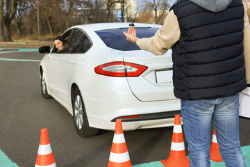 Instructor and student in car during exam on test track. Driving school
