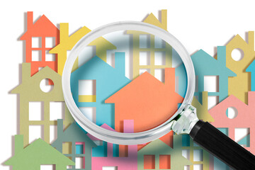 Real estate agent looks at the houses through a magnifying glass - Searching new home concept with...
