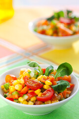 Healthy vegetarian vegetable salad with corn, tomatoes and cucumber