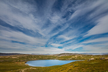 Fototapeta na wymiar Tundra landscape in west Greenland with lake and cirrus clouds