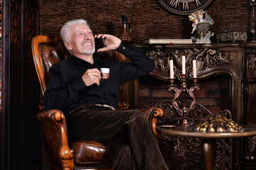 Portrait of smiling senior man drinking coffee