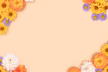 Frame made of arnica and dahlia flowers on a beige background with copyspace. Nature concept for...
