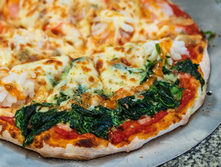 Spinach and Seafood Pizza made fresh from the oven