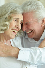 portrait of happy beautiful senior couple posing at home