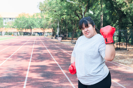 Portrait images of Asian fat woman Wearing a  boxing gloves, concept to fat woman health with weight loss and exercise.