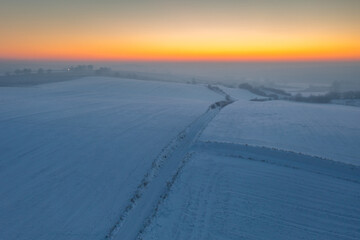 Fototapeta na wymiar Winter scenery of Kociewie fields at sunset. Poland