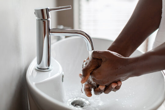 Cropped Shot Of Black Guy Washing Hands With Soap Indoor