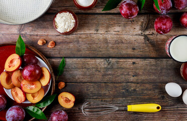 Making plum pie process, ingredients on wooden table.