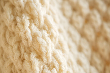 closeup beige knitted woolen fabric texture background