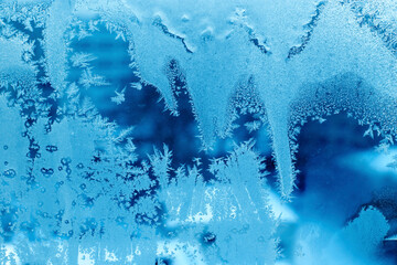 Beautiful ice pattern close-up on winter window glass