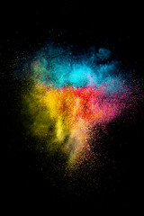 Explosion of colored, fluid and neoned powder on black studio background with copy space. Magazine cover, wallpaper design