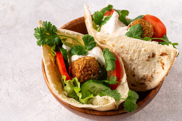 Falafel and fresh vegetables in pita bread