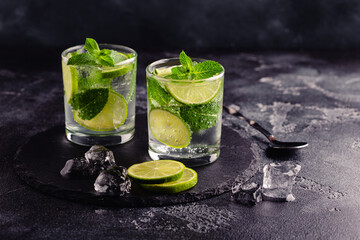 Refreshing summer alcoholic cocktail mojito with ice, fresh mint and lime