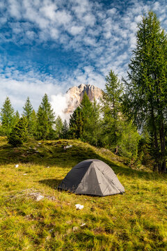 Sunrise morning view of green tent and Tofane mountains Tofana di Rozes in background. Autumn camping in Dolomites, Trentino Alto Adige region, South Tyrol, Italy, Europe.