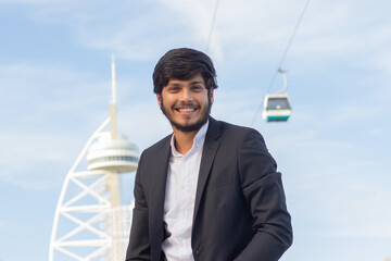 Portrait of good-looking smiling Arabic man. Attractive young businessman in suit with beard and...