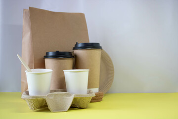 Eco-friendly containers ,a paper food bag on a yellow background. Without plastic. Takeaway food. Place for your text