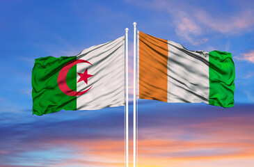 Algeria and Côte d'Ivoire two flags on flagpoles and blue cloudy sky