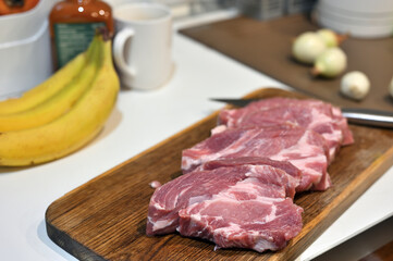 Raw pork meat on kitchen table.