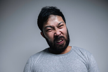 Obraz premium Asian handsome man angry on white background,Portrait of young Stress male concept