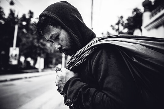 Asian Man Is Homeless At The Side Road,A Stranger Has To Live On The Road Alone Because He Has No Family.