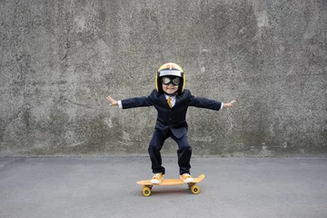 Poster Funny businessman riding skateboard outdoor © Sunny studio