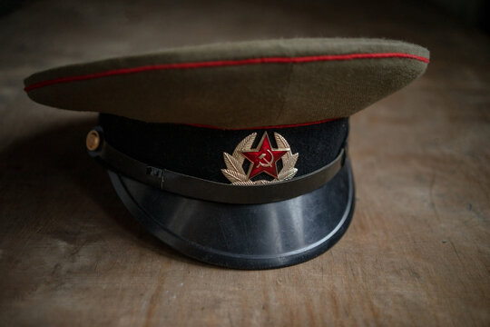 A Soviet military cap on a wooden table. Uniform of a soldier from the USSR