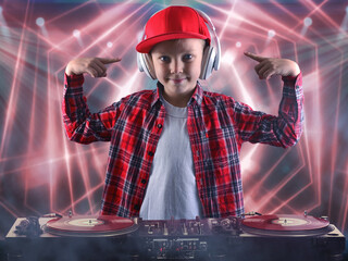 The little boy in the style of Hip-Hop .Cool rap dj. Children's fashion.Cap and jacket. The Young...