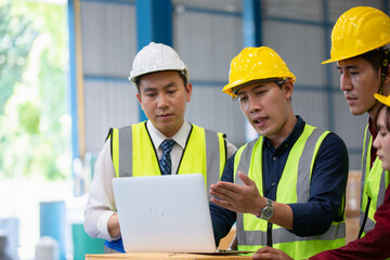  Warehouse worker meeting. Employee asian people using laptop in factory