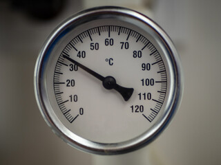 A temperature gauge showing the water temperature in the pipeline system in a private house.