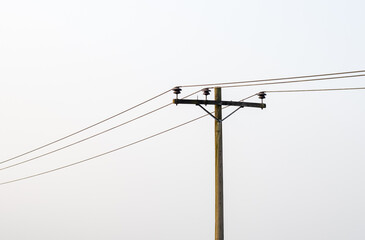 Electricity transmission pole under the foggy sky