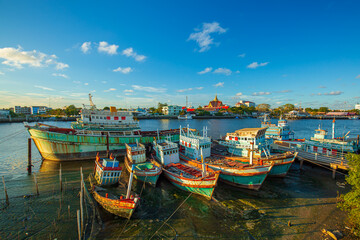 Fototapeta na wymiar Fishing port and beautiful sky in Asia,Many boats moored in sunrise morning time at Chalong port, Main port for travel ship to krabi and phi phi island, Phuket, Thailand