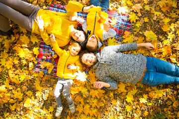 Happy family of forth in autumn park
